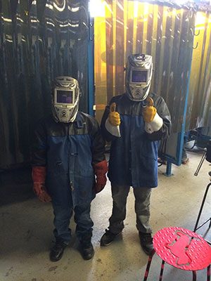 two kids wearing welding gear