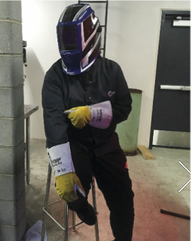 State of the Art: A MANS high school student models new welding gear with Star Wars style.