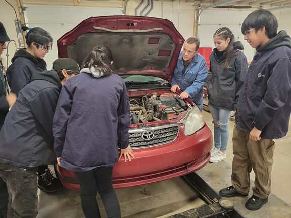 Students from Grade 10-12 are keen to learn and apply practical auto mechanics skills in the first auto mechanics class to be offered at MANS this November. Photo credit: Mike Willing